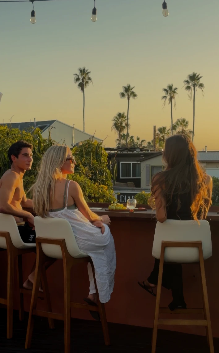 Guests at the terrace bar at sunset